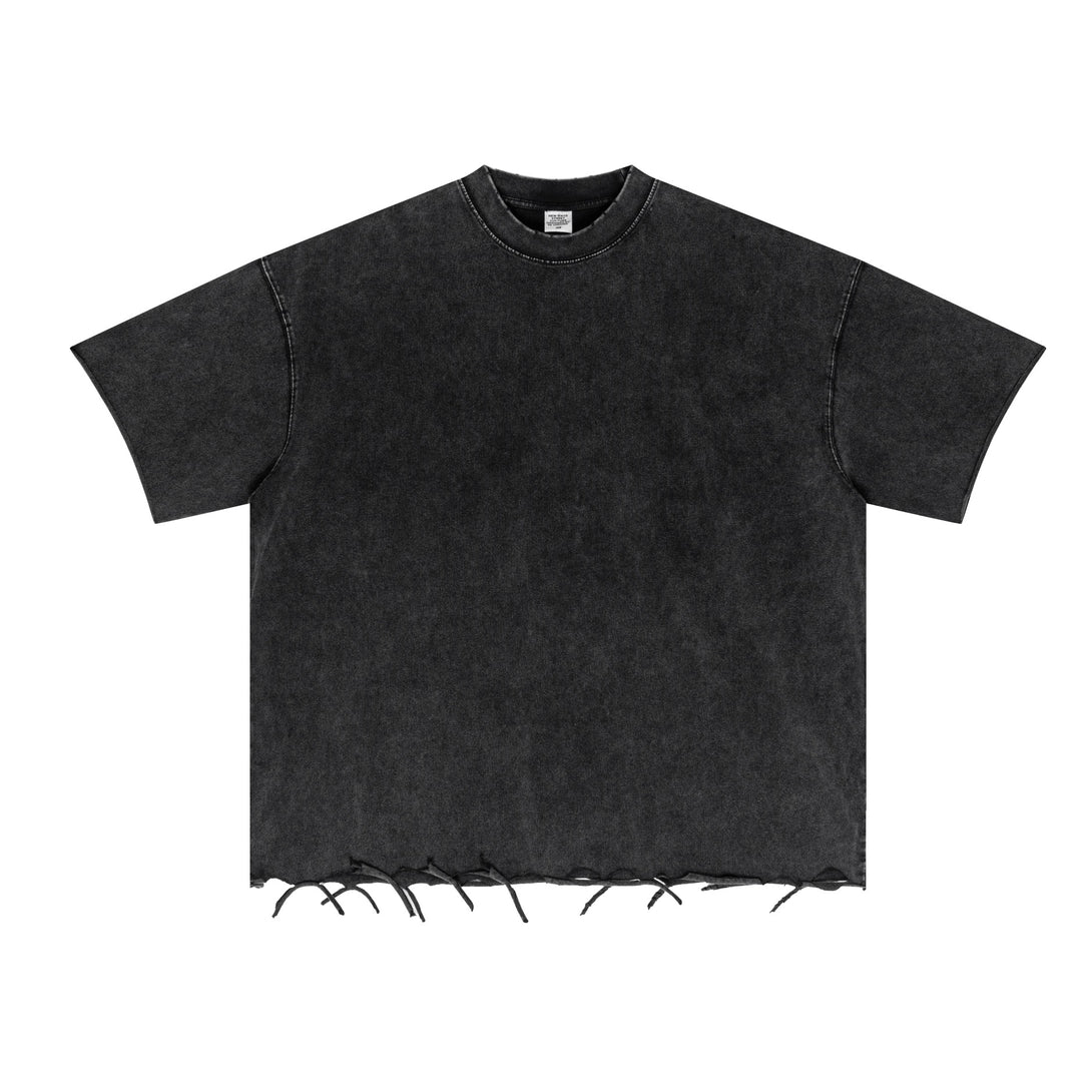 Black oversized cotton tee front with pigment dye texture and distressed trim, bulk order staple.