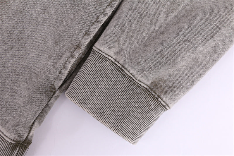 Cuff detail showing ribbed construction on round-neck distressed washed vintage sweatshirt