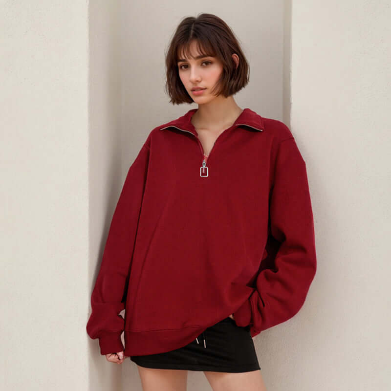 Model wearing a Semi Zip Sweatshirt in burgundy with stand collar and semi-zip closure.