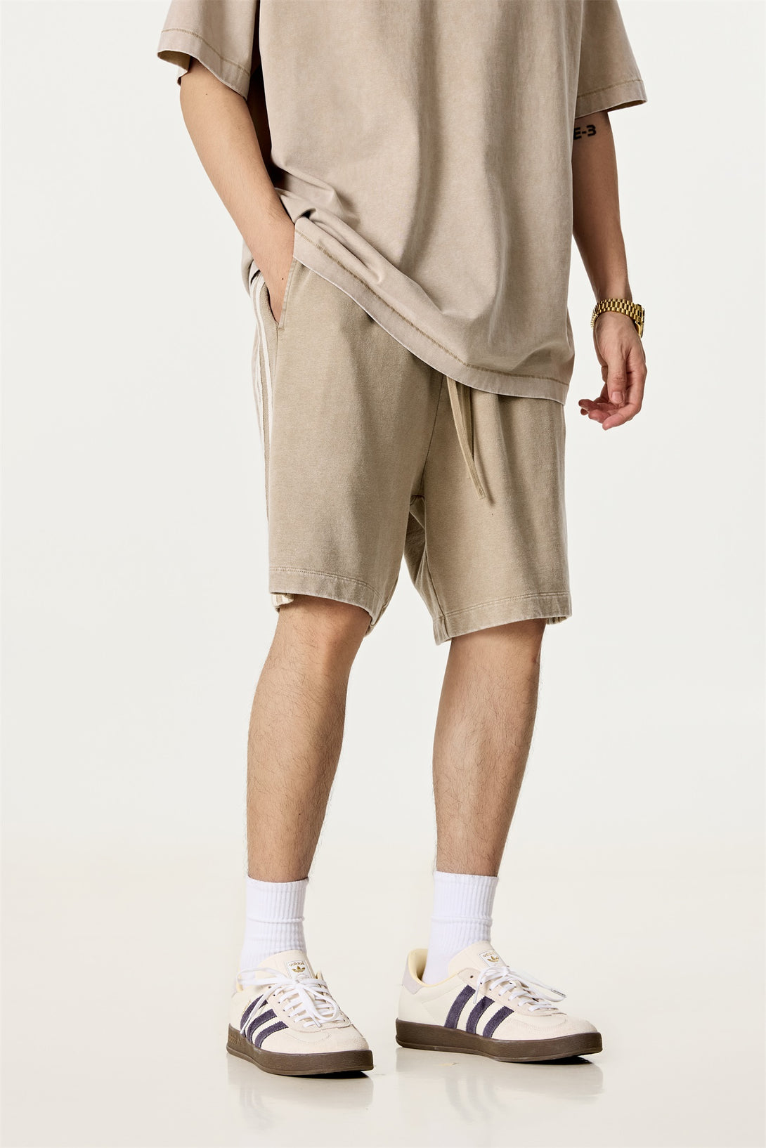 Model wearing streetwear snow wash shorts, front view