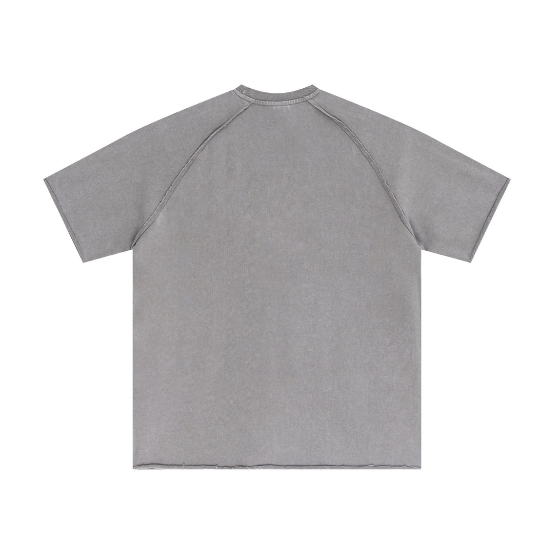 Light gray raw-edge cotton tee back perspective with snow-wash effect. Bulk oversized apparel essential.