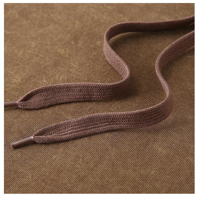 Vintage Wash Hoodie brown drawstrings on a textured fabric background.