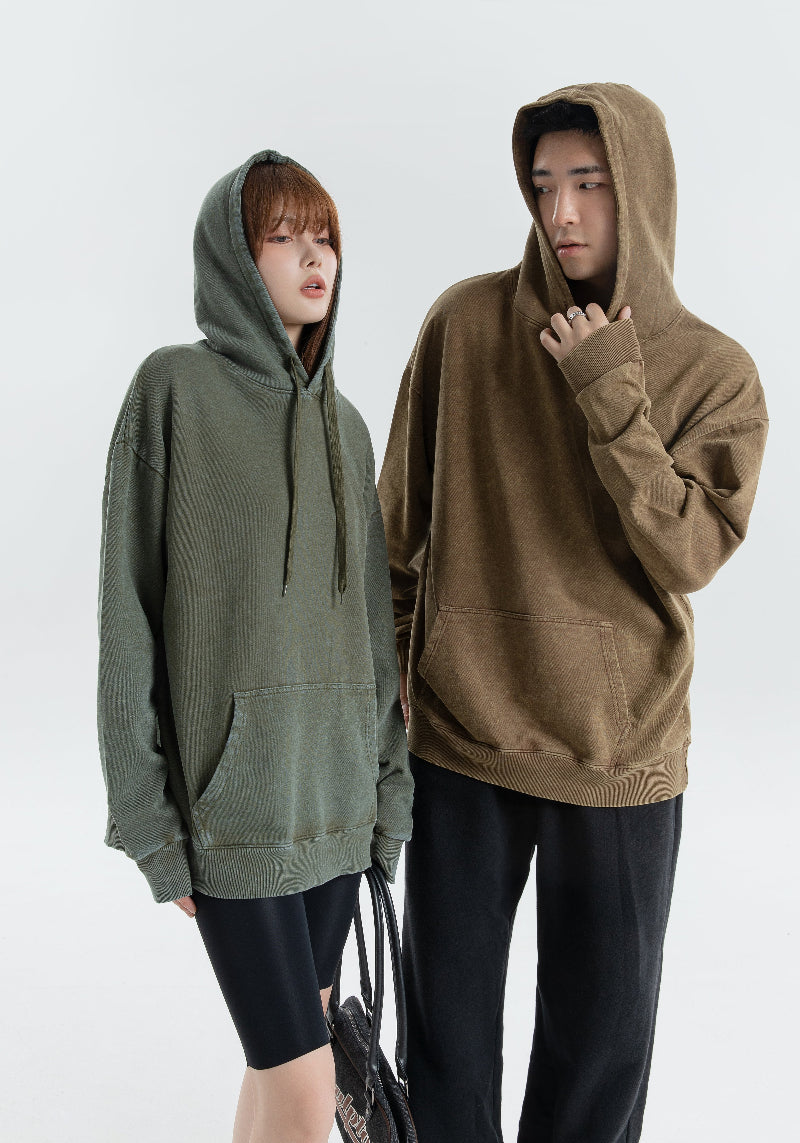 Vintage Wash Hoodie in vintage green and brown worn by models on a light background, highlighting its unisex style and classic design.