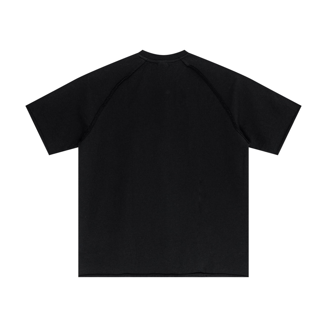 Black vintage streetwear tee back showcasing snow-wash texture and raw-edge trim. Wholesale unisex apparel item.