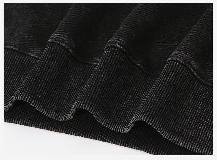 Hem stitching detail on wax-dyed pullover hoodie