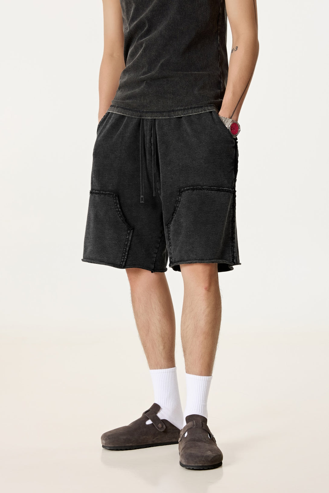 Model wearing men's streetwear wax wash shorts, front view