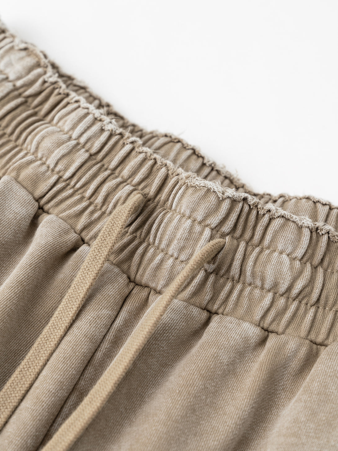 Close-up of drawstring waistband with wax wash crackle effect