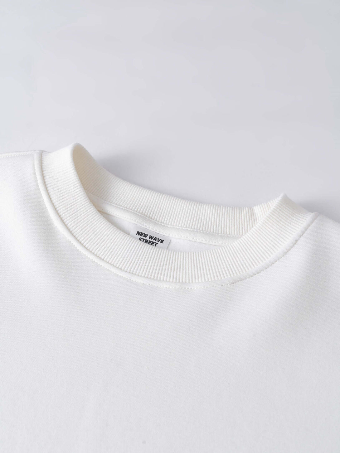 Men's 340g White Layered Camo Sweatshirt featuring a close-up of the collar detail and label.