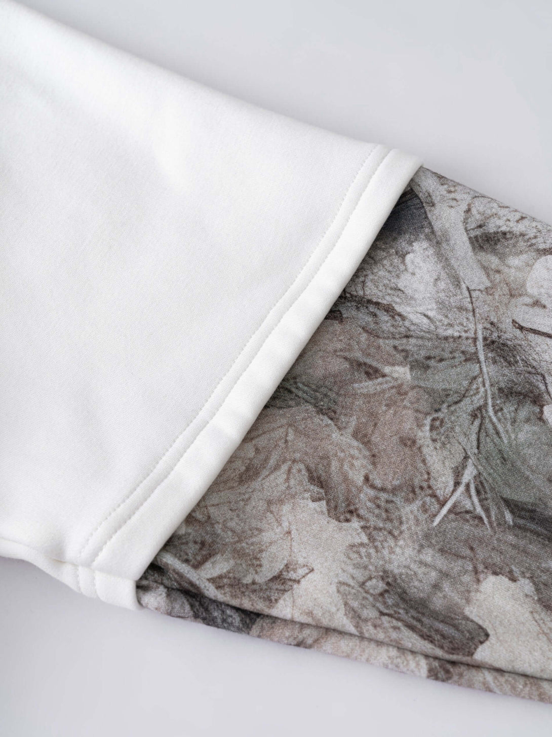 Men's 340g White Layered Camo Sweatshirt showcasing the distinctive two-layer sleeve and camouflage details.