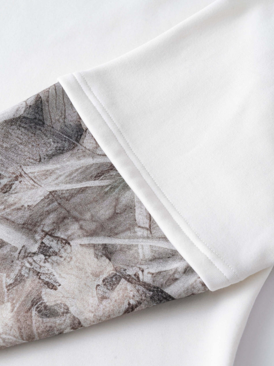 Men's 340g White Layered Camo Sweatshirt showcasing the unique two-layer sleeve design with decorative camouflage patterns.