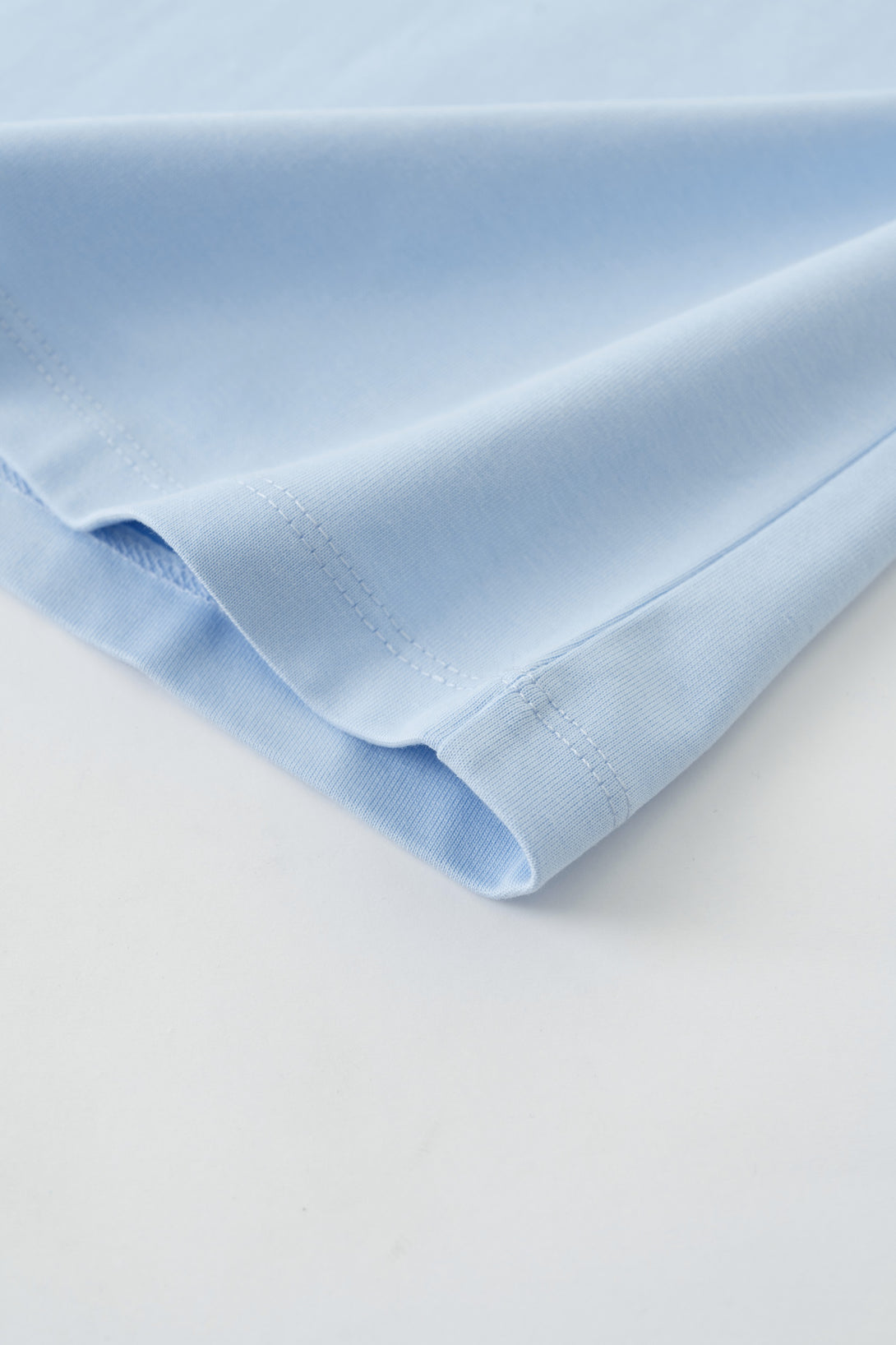 Hem stitching on Light Blue women's tee - double-stitched reinforcement