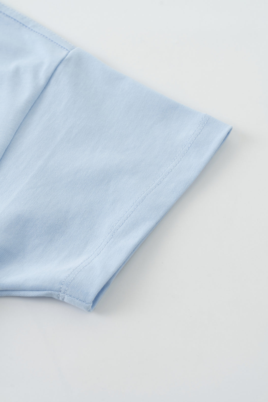 Sleeve detail of athletic t-shirt - breathable cotton construction for movement