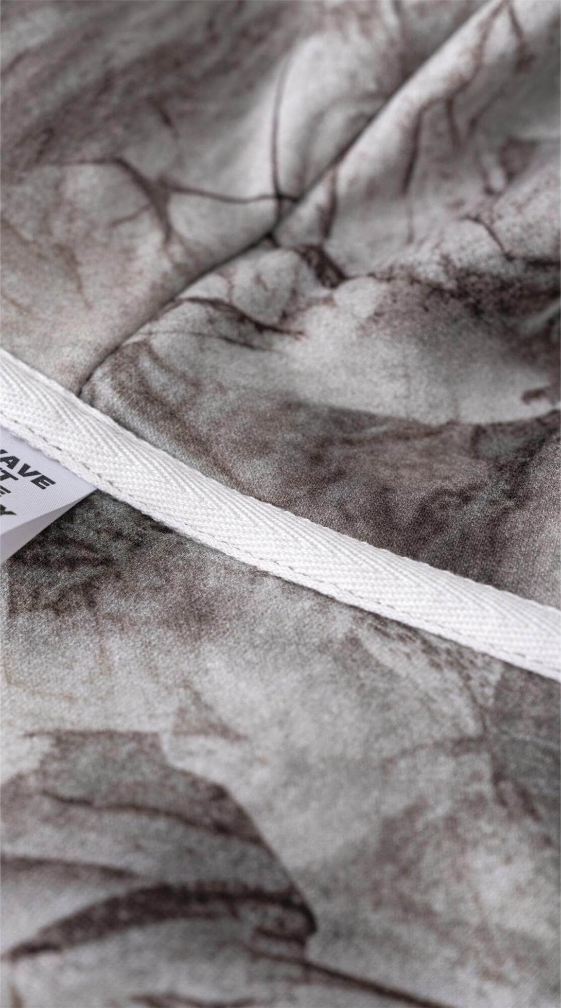Men's Woodland Camo Hoodie fabric detail showcasing heat transfer print and quality stitching.
