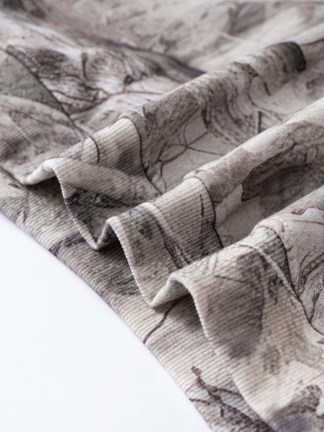 Close-up of the fabric of Men's Woodland Camo Hoodie, showcasing the heat transfer camouflage print design.