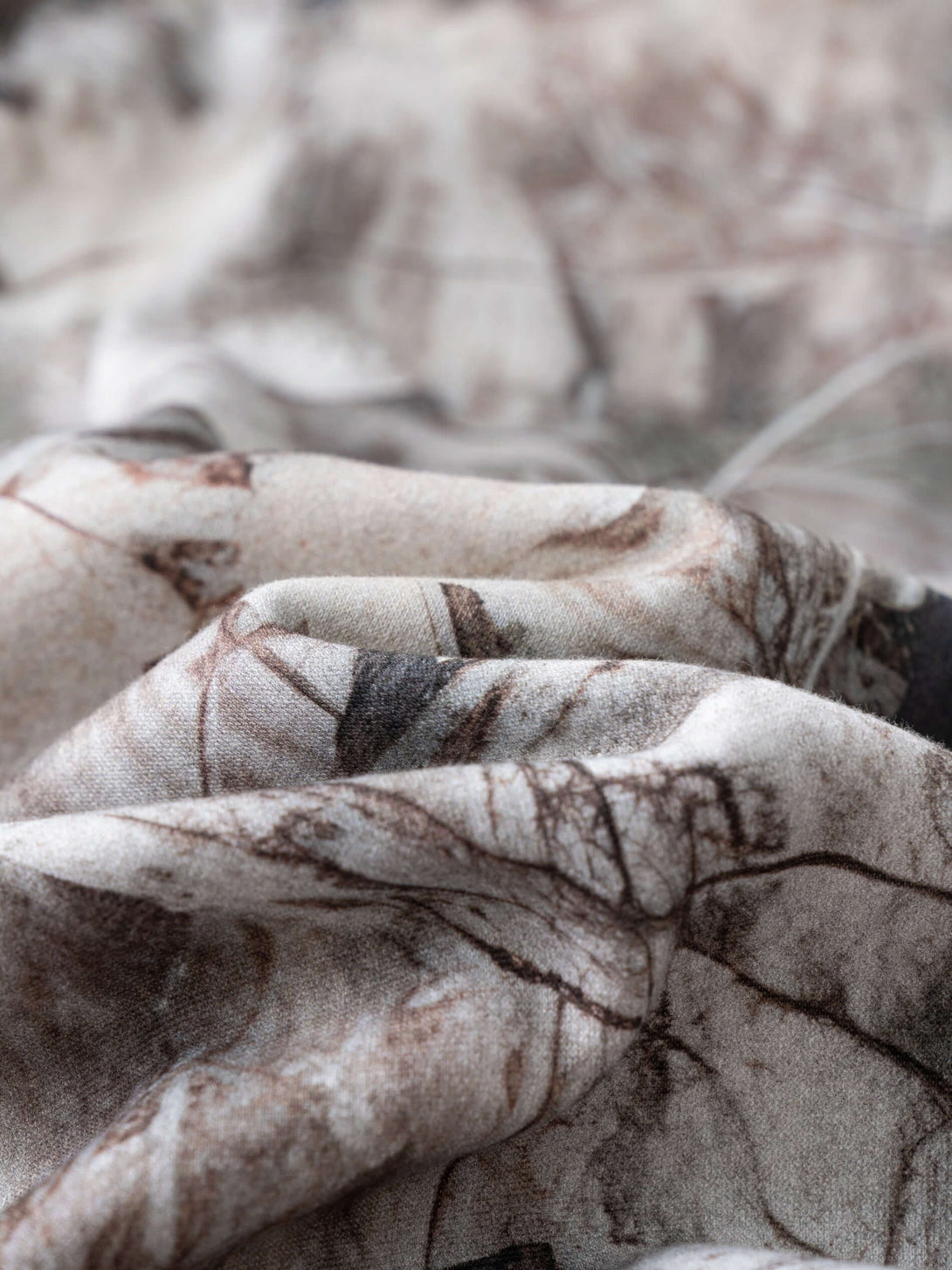 Close-up of the fabric showcasing the intricate print of the Men's Woodland Camo Hoodie.