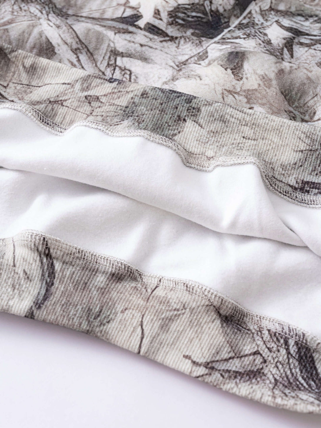 Men's Woodland Camo Hoodie close-up of heat transfer camouflage print and fabric detail.
