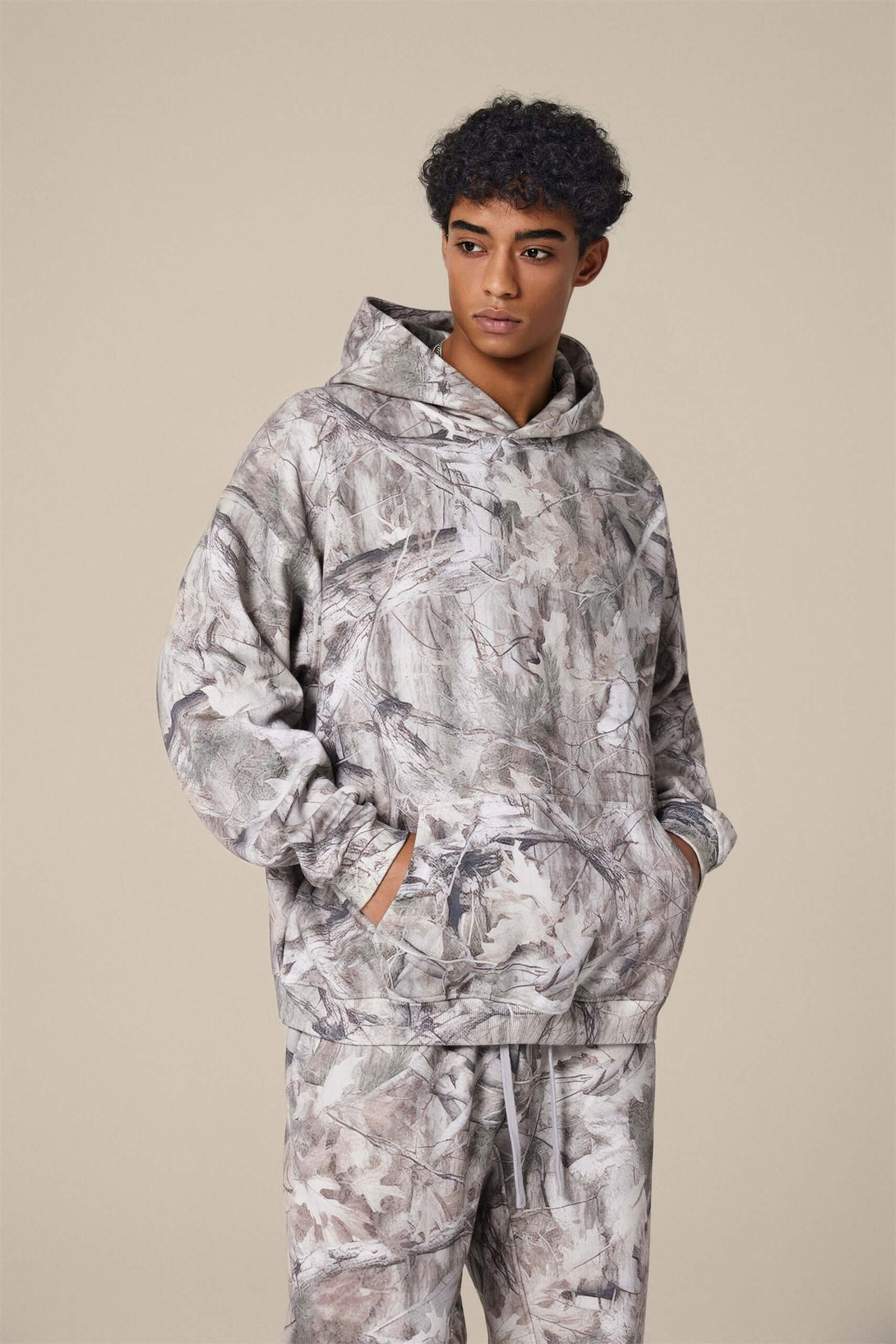 Men's Woodland Camo Hoodie on a model, showcasing heat transfer print design and comfortable fit.