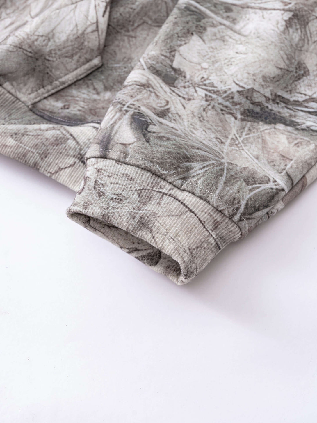Men's Woodland Camo Hoodie detail showing the fabric texture and design of the sleeves.