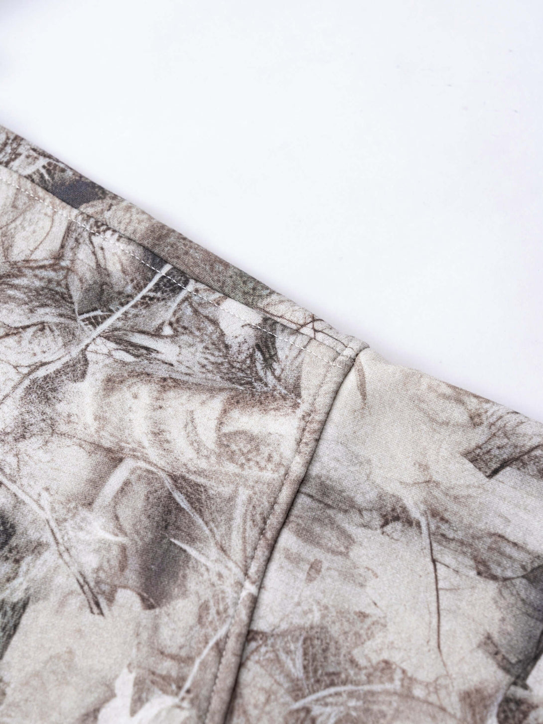 Men's Woodland Camo Hoodie fabric close-up showing heat transfer print detail and high-quality construction.