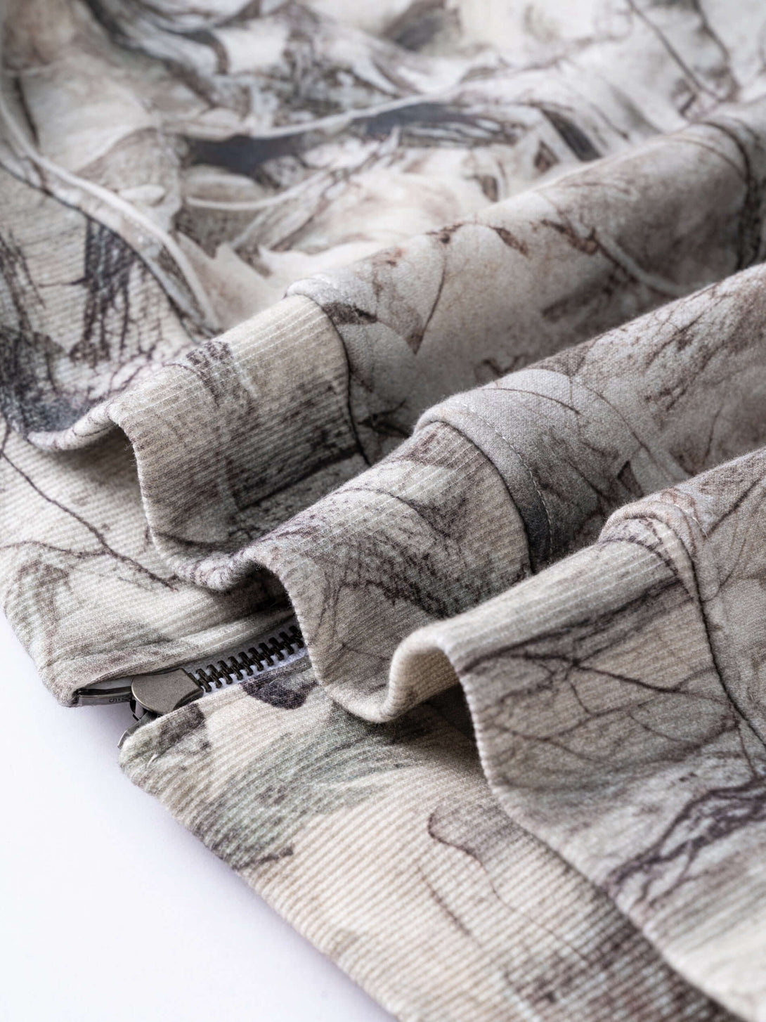 Men's 340g Woodland Camo Zip Up Hoodie fabric close-up, showcasing camouflage pattern and quality stitching.