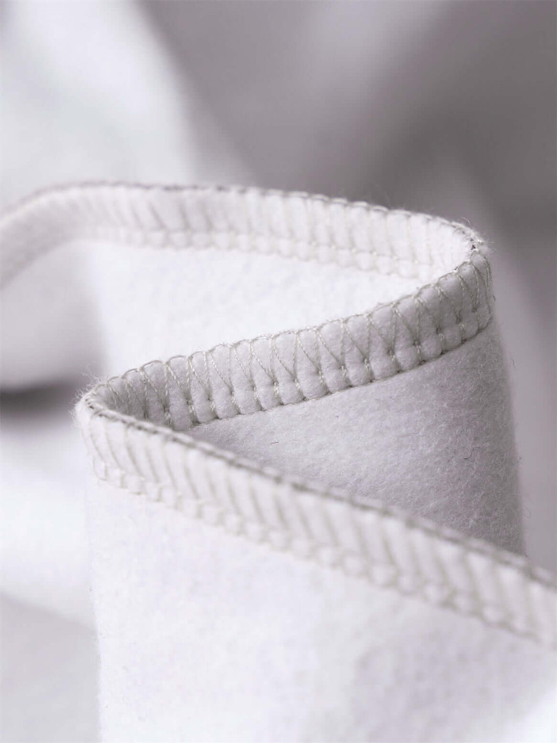 Close-up of the stitching detail on a Men's 340g Woodland Camo Zip Up Hoodie fabric.