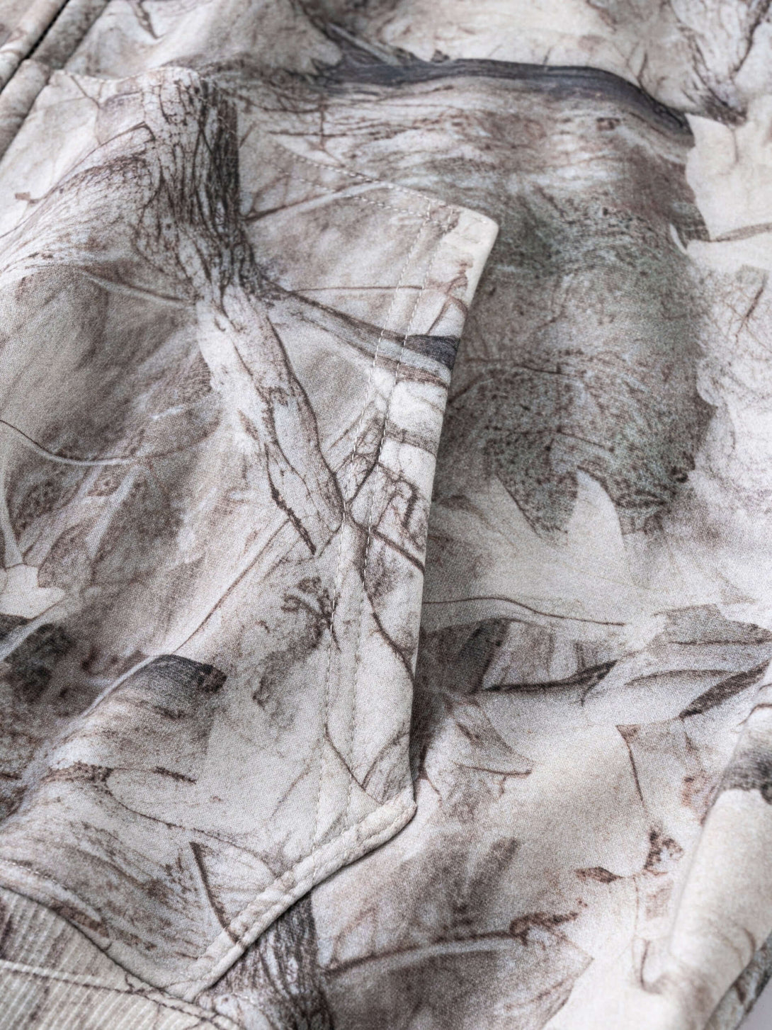 Men's 340g Woodland Camo Zip Up Hoodie close-up showcasing the detailed camouflage print and fabric texture.