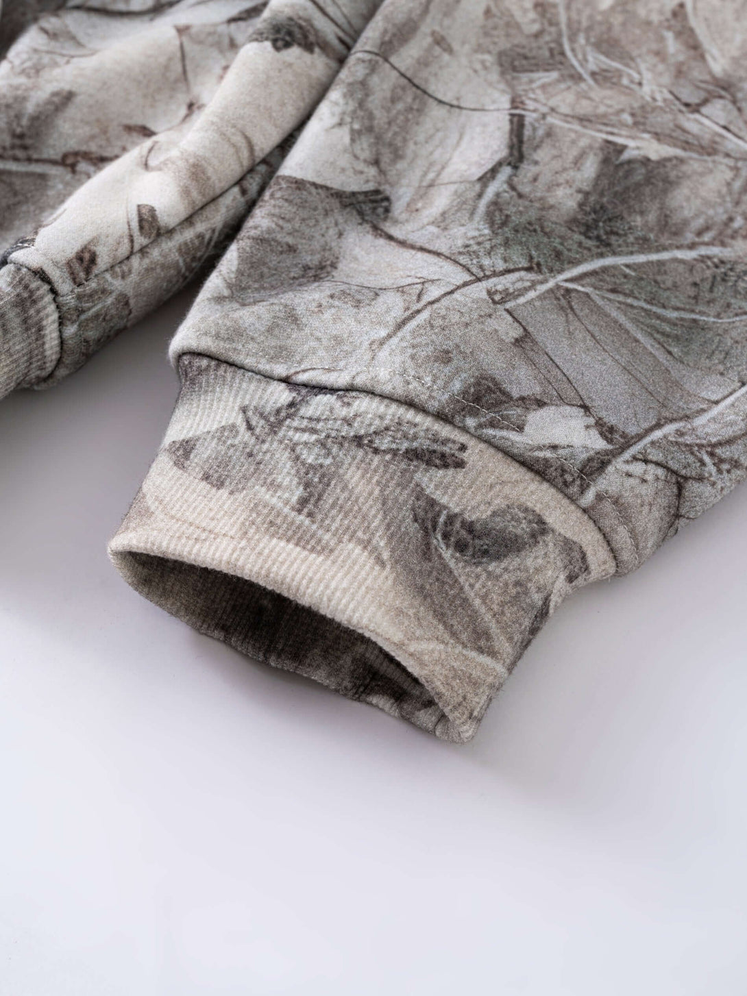 Men's 340g Woodland Camo Zip Up Hoodie showcasing detailed camo print and ribbed cuffs.
