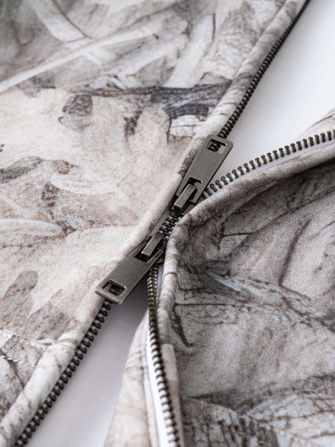 Men's 340g Woodland Camo Zip Up Hoodie showcasing the durable zipper and camouflage print detail.